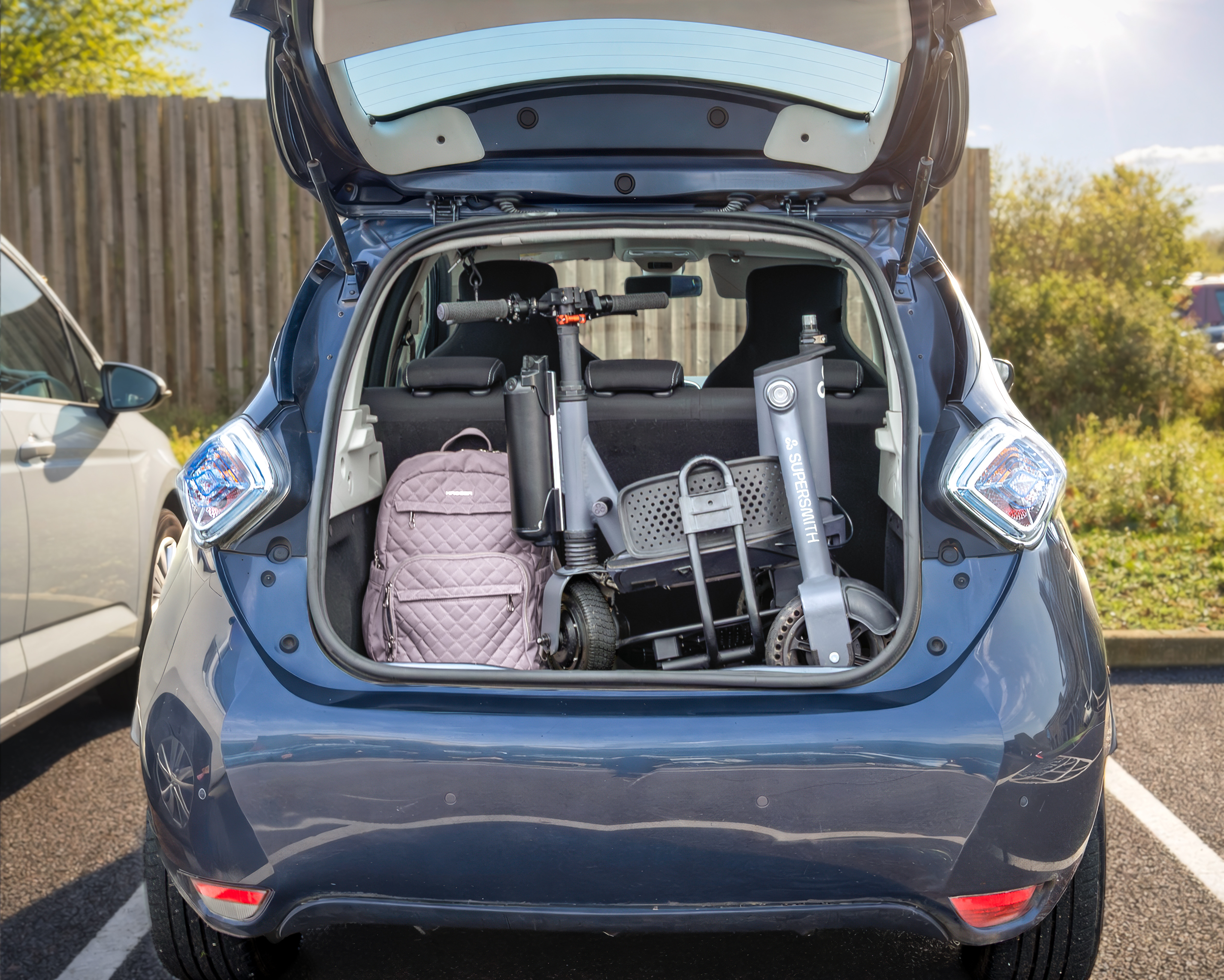 Photograph showing the 3Scooter folded away in an open car boot